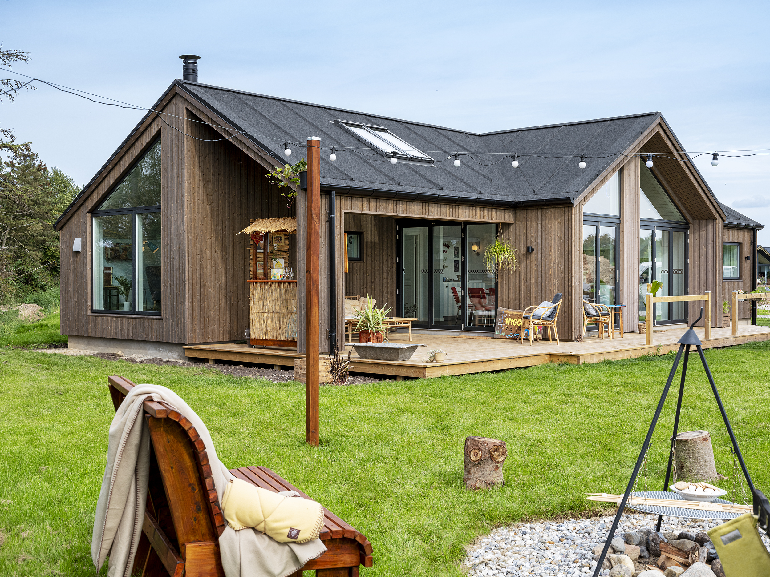 Brunt sommerhus og billeder af udeareal